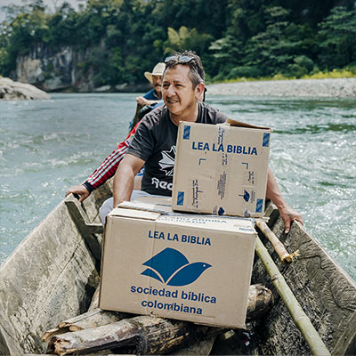 People transporting boxes in canoe